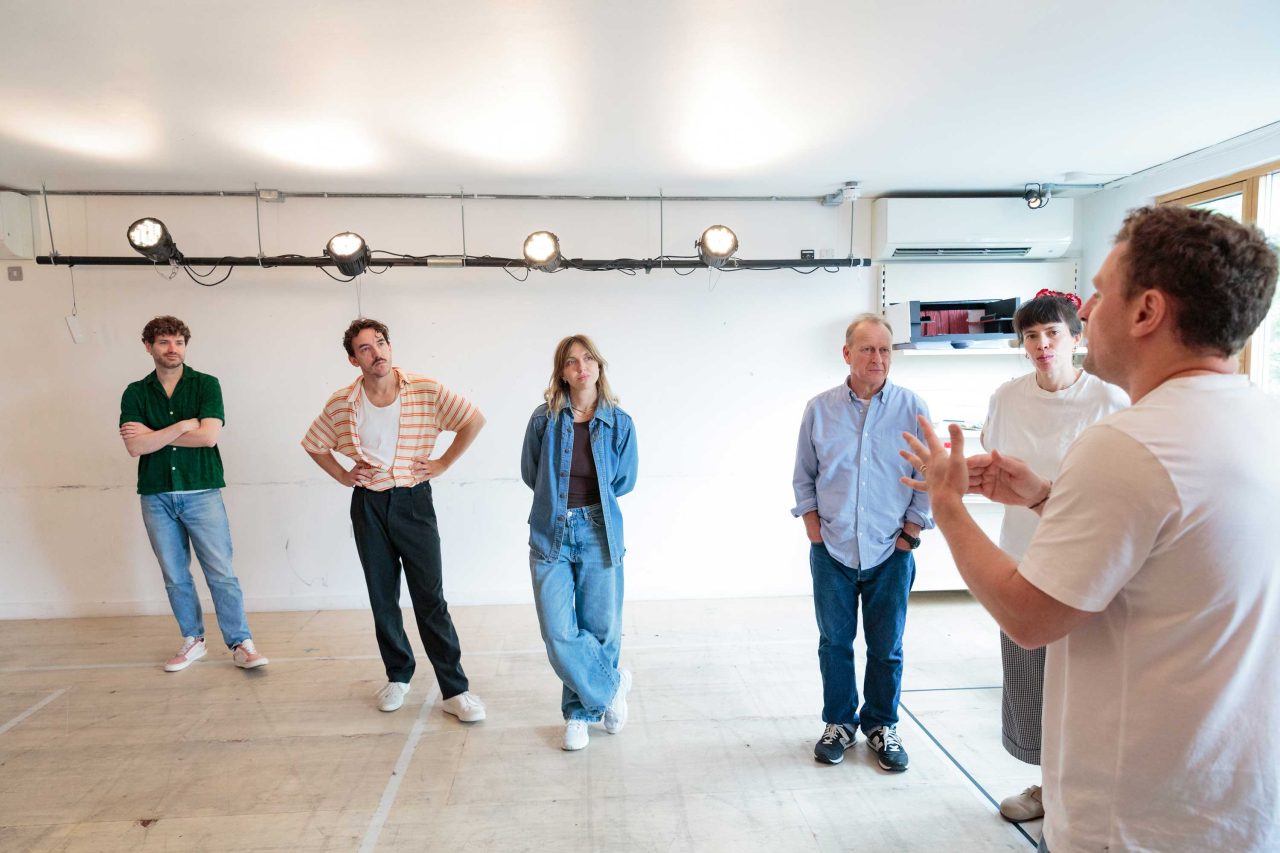 6 peaople standing rehearsing a play in the Morris space.