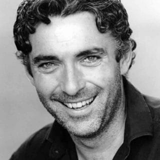 Mark-Cameron smiling for a photo