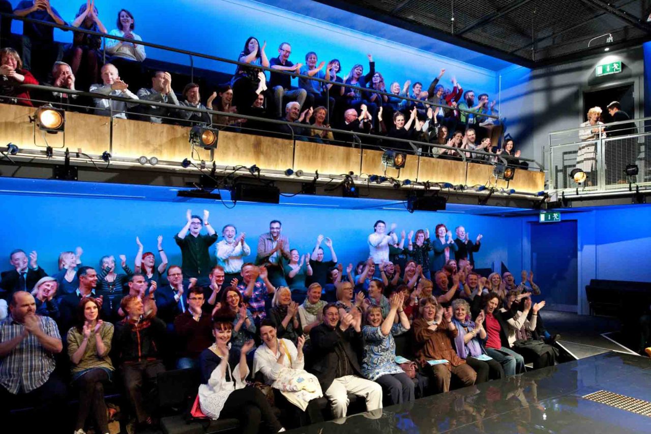 Park 200 Theatre Space with audience cheering and clapping