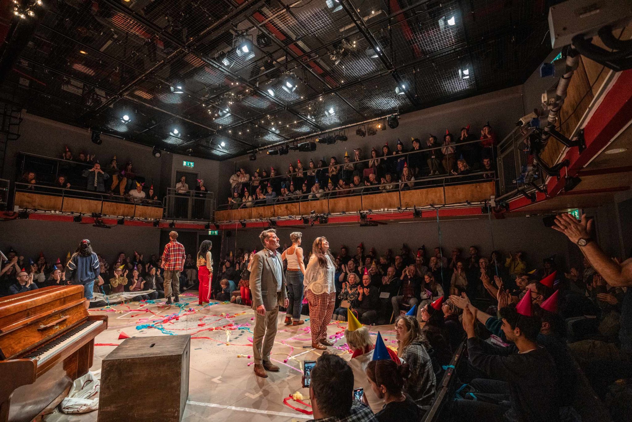 A full audience in Park 200 cheering and clapping as the cast look up about to bow.