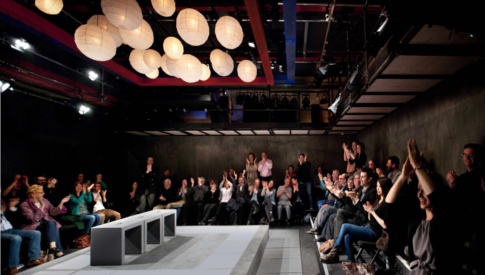 Inside the Park 90 Theatre with the audience clapping after a performance.