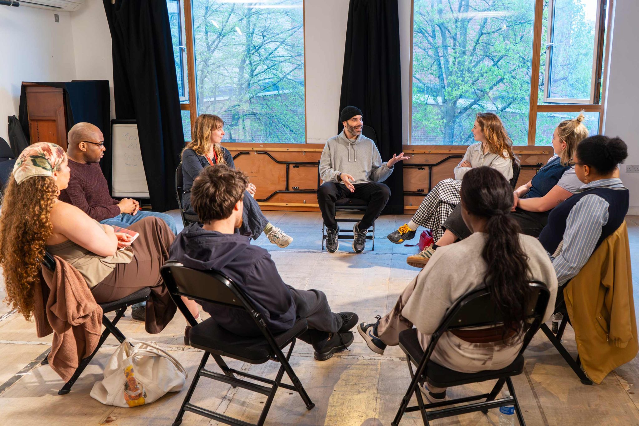 Morris Space, with a group of young adults sitting on chairs chatting