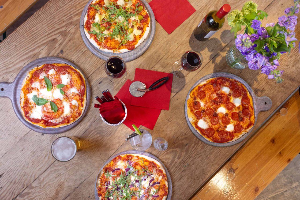 Photo of delicious pizza and wine on a table
